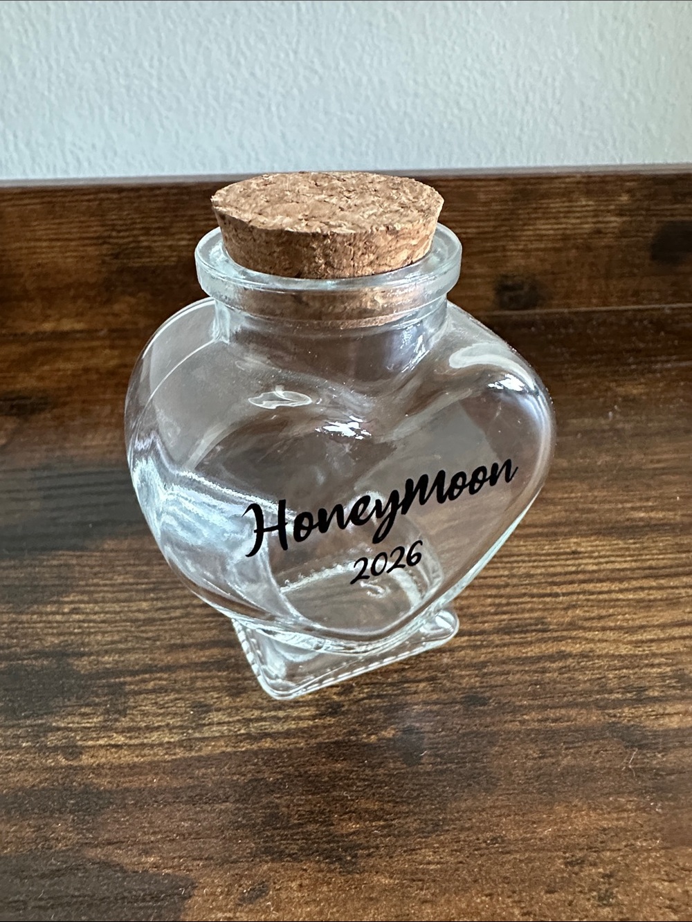 Clear Heart-Shaped Glass Jar with Cork Lid and “Honeymoon 2026”